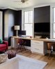 Modern home with Office, Chair, Desk, Study Room Type, Storage, Light Hardwood Floor, and Rug Floor. “The first floor has a separate home office were we flipped the exterior color palette by painting the walls black and the windows white,” says Hawthorn Builders. Photo 4 of Mid Century Style