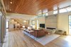Modern home with Living Room, Table Lighting, Chair, Sectional, Light Hardwood Floor, Ceiling Lighting, Console Tables, Ribbon Fireplace, Sofa, and Lamps. Mount Pleasant Modern: Living Room Photo 5 of Mount Pleasant Modern