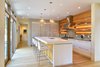 Modern home with Kitchen, Metal Backsplashe, Refrigerator, Range Hood, Range, Ceiling Lighting, Undermount Sink, Concrete Counter, Pendant Lighting, Light Hardwood Floor, White Cabinet, and Recessed Lighting. Mount Pleasant Modern: Kitchen Photo 8 of Mount Pleasant Modern