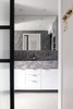 Modern home with Bath Room, Marble Wall, Drop In Sink, Marble Counter, Wall Lighting, Enclosed Shower, Recessed Lighting, and Ceramic Tile Floor. Grey marble, white wood, black metal and glass doors, along with brass accents, creates a contemporary and calming master bathroom. Photo 10 of Quarry Bay Residence