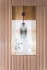 Modern home with Storage Room and Cabinet Storage Type. Brass punch out that frames the view into the kitchen. Lim + Lu focused on framing internal views around the apartment. Photo 4 of Quarry Bay Residence