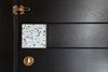 Detail of main entry door with custom terrazzo and brass door handle Photo 17 of Quarry Bay Residence modern home