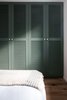 Modern home with Bedroom, Recessed Lighting, Bed, and Medium Hardwood Floor. A muted green closet design adds a pop of color and sophistication to the guest bedroom Photo 13 of Quarry Bay Residence