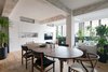Modern home with Living Room, Medium Hardwood Floor, Chair, Media Cabinet, Recessed Lighting, Sofa, Table, and Storage. Untouched, chipped orange and green painted concrete beams are a major element throughout the apartment, adding a patina that cannot be replicated through modern processes Photo 8 of Quarry Bay Residence