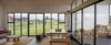 Modern home with Dining Room, Two-Sided Fireplace, Table, Storage, Concrete Floor, Bench, Wall Lighting, and Ceiling Lighting. interior house Photo 5 of House GM