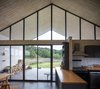Modern home with Kitchen, Concrete Floor, Laminate Cabinet, Refrigerator, Ceramic Tile Backsplashe, Wall Oven, Wall Mount Sink, Microwave, Wood Counter, Ceiling Lighting, Dishwasher, Drop In Sink, and Wall Lighting. Interior House Photo 6 of House GM