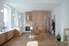 Modern home with Dining Room, Chair, Medium Hardwood Floor, Wall Lighting, Table, Accent Lighting, and Storage. Designed by Dratler Duthoit, this apartment greets visitors with an illuminated central living space. Photo of Corner apartment in Strasbourg, France
