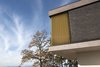 Modern home with Exterior, House Building Type, Metal Siding Material, Concrete Siding Material, Flat RoofLine, Wood Siding Material, and Brick Siding Material. Close view of the exposed concrete slabs , brick wall and aluminium louvers Photo 5 of Villa Rambo