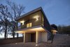 Modern home with Exterior, Wood Siding Material, Flat RoofLine, Concrete Siding Material, House Building Type, and Metal Siding Material. Main exterior view at sunset Photo of Villa Rambo
