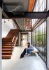 Modern home with Staircase, Metal Tread, and Wood Railing. Estúdio Penha introduced floor-to-ceiling, iron-framed picture windows that fill this home with light. Photo 9 of Conde D'eu House