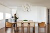 Modern home with Dining Room, Chair, Medium Hardwood Floor, Pendant Lighting, and Table. Sliding door panels between the kitchen and dining room allow the spaces in JB Apartment to be easily rearranged. Photo of The JB apartment