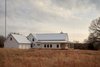Modern home with Exterior, House Building Type, Wood Siding Material, Gable RoofLine, and Metal Roof Material. Street View Photo 2 of OKC Farmhouse