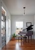 Modern home with Living Room, Pendant Lighting, and Medium Hardwood Floor. The front entry was designed with a family heirloom baby grand piano in mind. Photo 3 of OKC Farmhouse