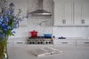 Modern home with Kitchen, Recessed Lighting, Range Hood, Engineered Quartz Counter, Medium Hardwood Floor, Range, White Cabinet, and Subway Tile Backsplashe. Kitchen Photo 7 of OKC Farmhouse