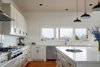 Modern home with Kitchen, Engineered Quartz Counter, Range, Range Hood, Recessed Lighting, Pendant Lighting, Dishwasher, White Cabinet, Undermount Sink, Medium Hardwood Floor, and Subway Tile Backsplashe. Kitchen Photo 8 of OKC Farmhouse