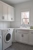 Modern home with Laundry Room, Side-by-Side, White Cabinet, and Engineered Quartz Counter. Laundry Photo 10 of OKC Farmhouse