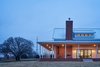 Modern home with Exterior, Wood Siding Material, Metal Roof Material, House Building Type, and Gable RoofLine. Back Porch Photo 17 of OKC Farmhouse