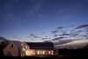 Modern home with Exterior, Gable RoofLine, Wood Siding Material, House Building Type, and Metal Roof Material. Street Side at Dusk Photo 20 of OKC Farmhouse
