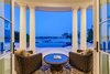 Modern home with Outdoor, Decking Patio, Porch, Deck, Flowers, Landscape Lighting, Hanging Lighting, Pavers Patio, Porch, Deck, Back Yard, Trees, Large Pools, Tubs, Shower, and Large Patio, Porch, Deck. Perched on tranquil bay waters, the back of the home is a tropical oasis, while the elegant front entry transports you to another world. From its tumbled travertine tile imported from Turkey to the antique sconces sourced from a Newport, Rhode Island mansion, classic New England style abounds. Photo 3 of Coastal Comfort and New England Elegance Siesta Key Bayfront Mansion