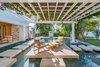 Modern home with Outdoor, Flowers, Gardens, Grass, Shrubs, Small Pools, Tubs, Shower, Hardscapes, Trees, and Back Yard. An al fresco kitchen offers endless opportunities for entertaining while multiple courtyards provide an escape for quiet reflection. Photo 7 of STRANDHUS, A MODERN LIDO SHORES ESTATE