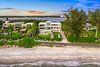 Modern home with Outdoor, Large Patio, Porch, Deck, Front Yard, Walkways, Gardens, Shrubs, Trees, Vertical Fences, Wall, Concrete Pools, Tubs, Shower, Large Pools, Tubs, Shower, and Grass. Master builder Michael K. Walker and Associates crafted the 6,552-square-foot, three-level residence with four en-suite bedrooms, two half baths, an office and elevator. Shell concrete floors and mahogany surfaces complement walls of windows that showcase stunning Gulf views; outdoor terraces can be accessed from every room. Photo 2 of Ultra-Contemporary Gulf-to-Bay Estate