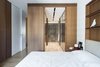 Modern home with Bedroom, Wardrobe, Shelves, Medium Hardwood Floor, Ceiling Lighting, and Bed. Bedroom and walk-in closet Photo 7 of House A326