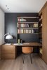 Modern home with Office, Chair, Shelves, Study Room Type, Medium Hardwood Floor, Lamps, and Desk. The black studio wall in House A326 stands out against the rest of the home's palette of white and concrete. Almost all of the furnishings were custom-designed by Studio DiDea and realized by local artisans. Photo 6 of House A326
