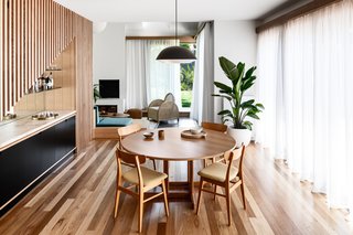 A compact dining room acts as a focal point of the home, with easy access to the living room and pool.