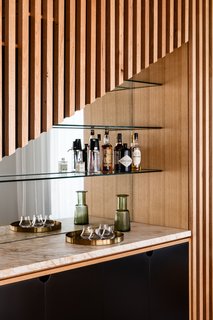 Happy hour has never looked so good. The home's wet bar receives stylish treatment with an asymmetrical facade and mirrored background.