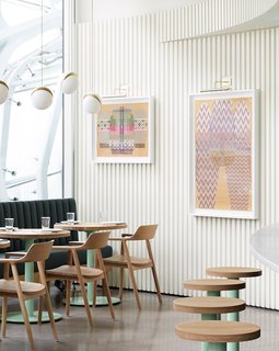 Colorful artwork adds some personality to the restaurant's textured, white walls.