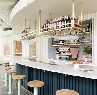 The 1,900-square-foot space features West Coast-cool elements like light wood barstools, slotted walls, and gilded accessories.