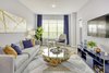Modern home with Living Room, Sofa, Ceiling Lighting, Console Tables, Coffee Tables, and Chair. Apartments at The Enclave range from studios to two-bedroom residences, with select homes offering private balconies. Design-driven living spaces include nine-foot ceiling heights and custom modular closets. Photo 7 of The Enclave