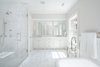 Modern home with Bath Room, Marble Counter, Freestanding Tub, Undermount Sink, Ceiling Lighting, Stone Slab Wall, Enclosed Shower, and Wall Lighting. Owner's Bath Photo 8 of The Piano Estate