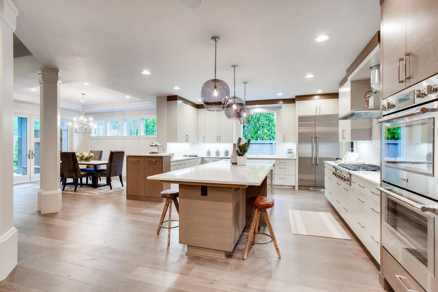 The open floor plan carries the eye line from the kitchen into the dining room and outdoor space. 
