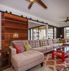 Modern home with Living Room, Coffee Tables, End Tables, Sectional, Ceiling Lighting, Floor Lighting, and Ceramic Tile Floor. Custom-built mahogany doors make a statement in the living room & give maximum privacy. Photo 9 of Maui Modern, Budget-Luxury Remodeled Vacation Rental