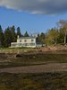 Modern home with Exterior, Wood Siding Material, Stone Siding Material, Gable RoofLine, Metal Roof Material, and House Building Type. View from tidal flats Photo of Bay of Fundy house