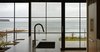 Modern home with Kitchen, Medium Hardwood Floor, Dishwasher, Quartzite Counter, Cooktops, Range, Wood Cabinet, Undermount Sink, Porcelain Tile Backsplashe, Refrigerator, Ceiling Lighting, and Range Hood. View from kitchen Photo 3 of Bay of Fundy house