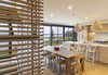 Modern home with Dining Room, Ceiling Lighting, Pendant Lighting, Stools, Table, Medium Hardwood Floor, and Chair. Kitchen dining area Photo 6 of Bay of Fundy house