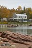 Modern home with Exterior, Stone Siding Material, House Building Type, Metal Roof Material, Wood Siding Material, and Gable RoofLine. View from across the inlet Photo 13 of Bay of Fundy house