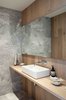 Modern home with Bath Room, Vessel Sink, Accent Lighting, Marble Floor, Marble Wall, One Piece Toilet, and Wood Counter. Grey marble and oak panels line powder room walls. Photo 7 of Gilbert House