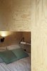 Modern home with Kids Room, Living Room Room Type, Bed, Bedroom Room Type, Family Room Room Type, Light Hardwood Floor, and Playroom Room Type. This sleeping area includes a bookshelf and sconce. Photo 5 of heva
