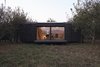 Modern home with Exterior, Shed RoofLine, Shingles Roof Material, Wood Siding Material, Prefab Building Type, and Cabin Building Type. A glimpse of Heva's interior and deck. Photo 18 of heva