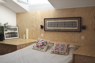 A small window illuminates the simple bedroom located next to the living area.