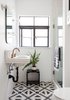 Modern home with Bath Room, Wall Mount Sink, One Piece Toilet, Cement Tile Floor, Enclosed Shower, and Ceiling Lighting. Graphic cement tile livens up the quaint guest bathroom, with a repurposed sink and new hardware. Photo 2 of Modern Spanish Revival