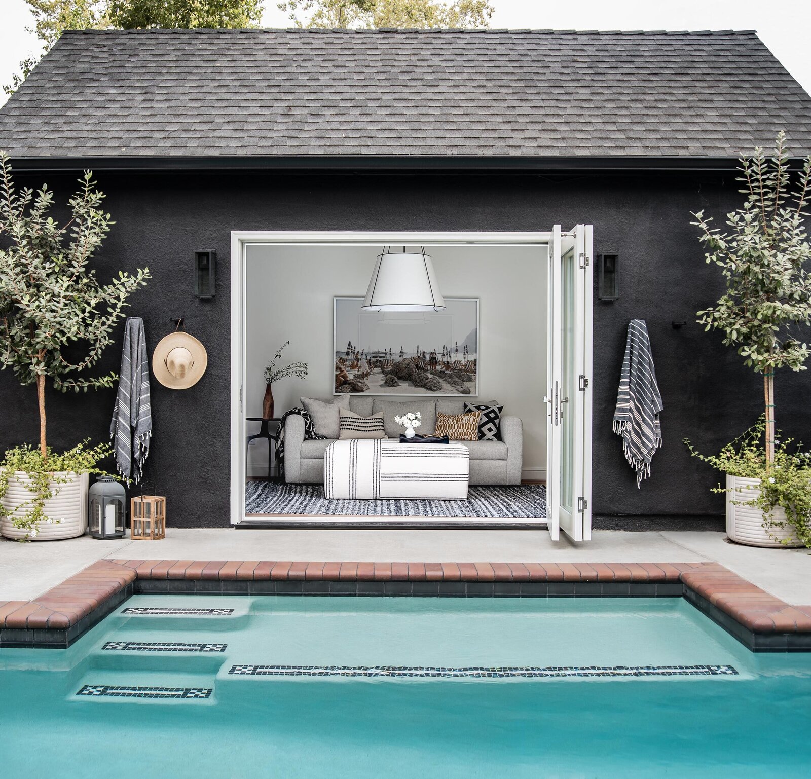 Sliding doors lead into the office/pool house, perfect for a guest room or focusing on work next to the water.
