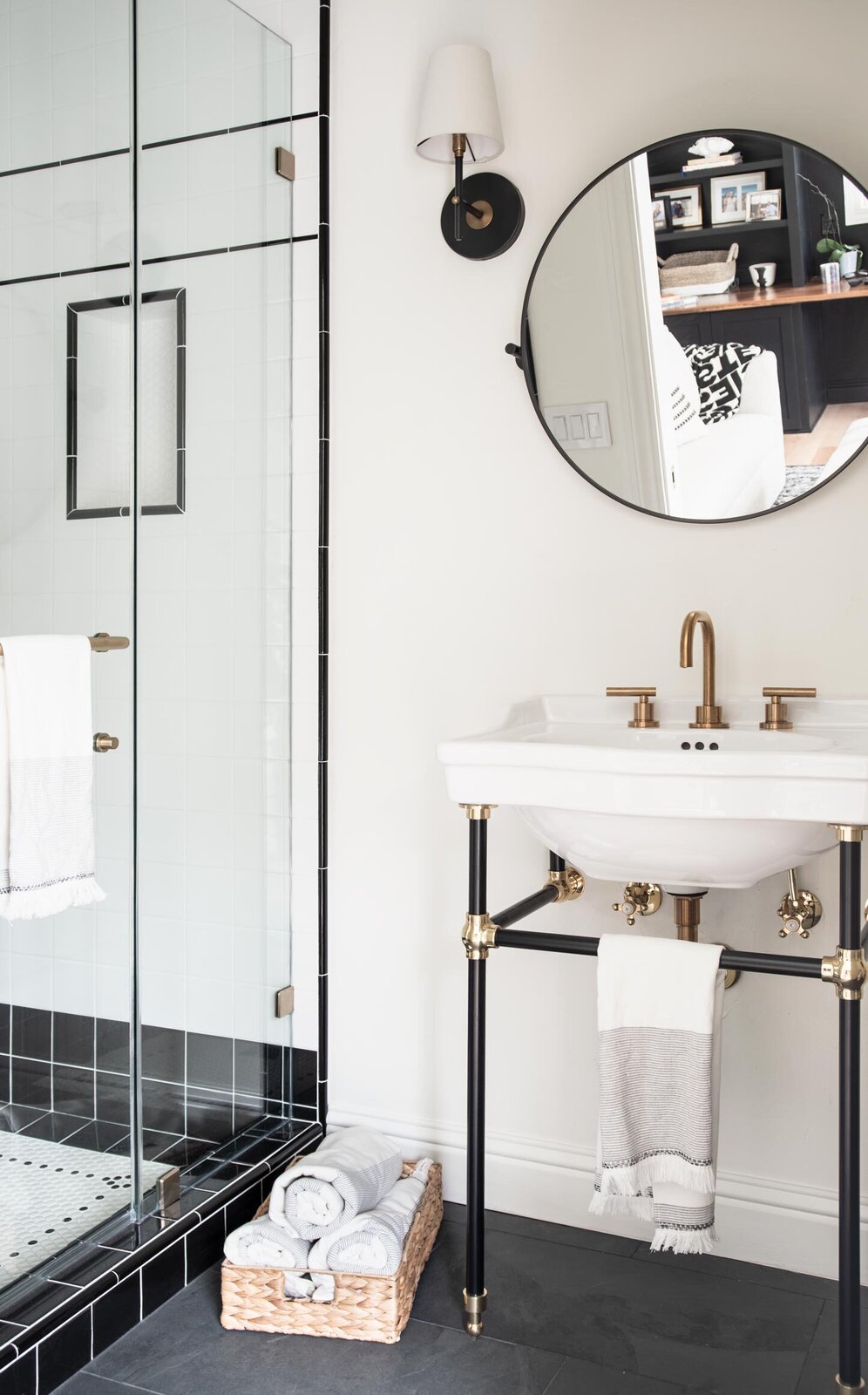 Black and white subway tiles are the perfect background for gold accents in the pool house bath.