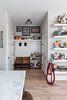 Modern home with Living Room. In a cove near the kitchen’s natural marble stone island, Stephen pays tribute to the American automat in black and white photography and tips a hat at his love of theatre with antique VIP seats from Charleston, SC. Photo 2 of Pinewood Forest Huxley Terrace Home