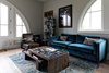 Modern home with Living Room, Coffee Tables, and Sofa. A club chair, spiral Blu-Ray collection, blue couch with throw pillows and coffee table of movie books set the stage for gatherings. Photo 4 of Pinewood Forest Huxley Terrace Home