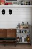 Modern home with Living Room. A bar stand in the shiplap-laced cove and coat rack by the pantry is always ready for Stephen’s storied Pinewood Forest gatherings. Photo 7 of Pinewood Forest Huxley Terrace Home