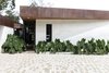Modern home with Exterior, Flat RoofLine, Stone Siding Material, House Building Type, and Metal Roof Material. Fachada Photo 14 of Entremuros House